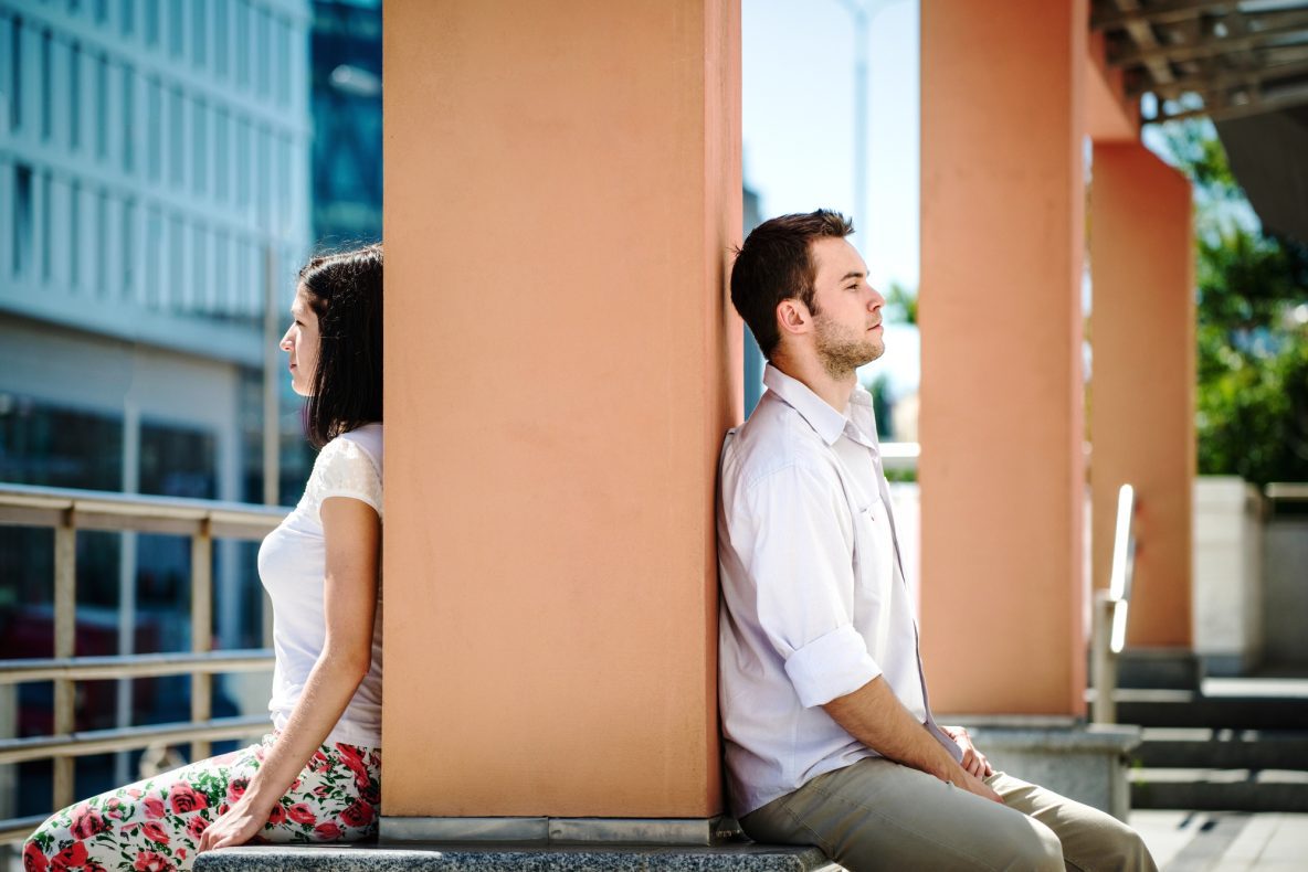 Couple sitting apart, showing emotional distance in a marriage